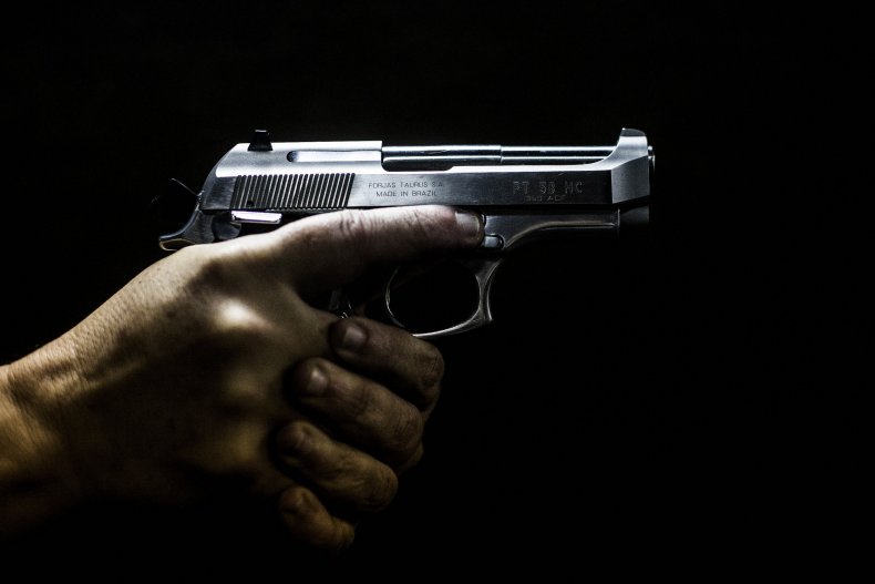 A man grips a gun in Brazil.