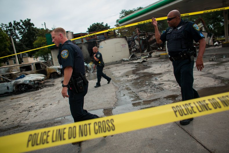 Police officers patrol the BP gas station