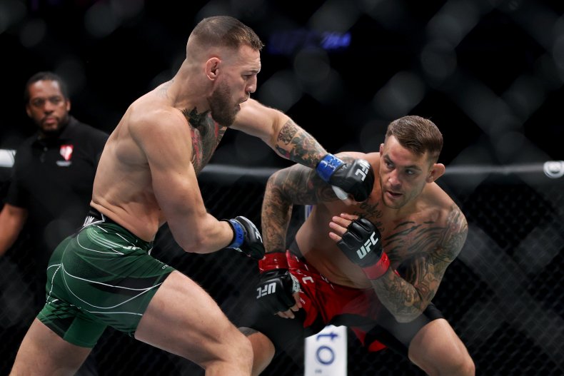 Conor McGregor attempts to punch Dustin Poirier.