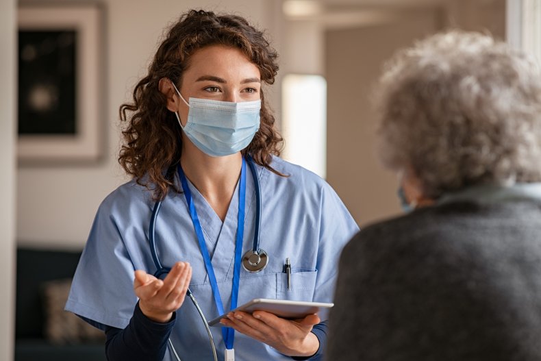 Nurse speaking with elder patient