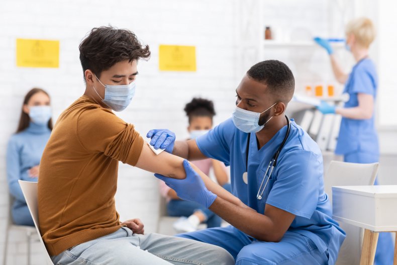 Male nurse giving shot stock
