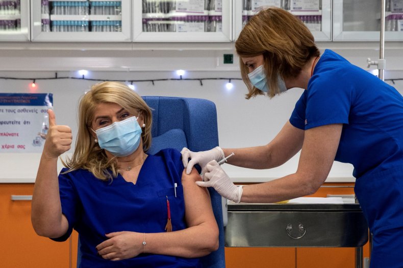 A Greek nurse receives her COVID vaccine