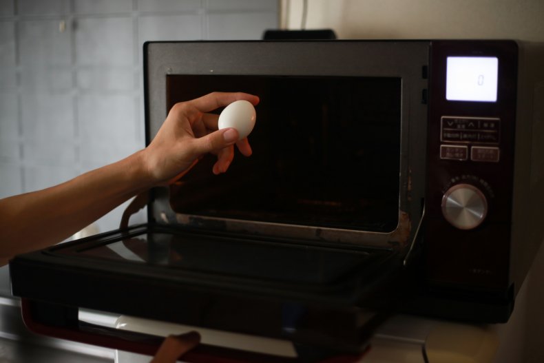 Egg being put in the microwave