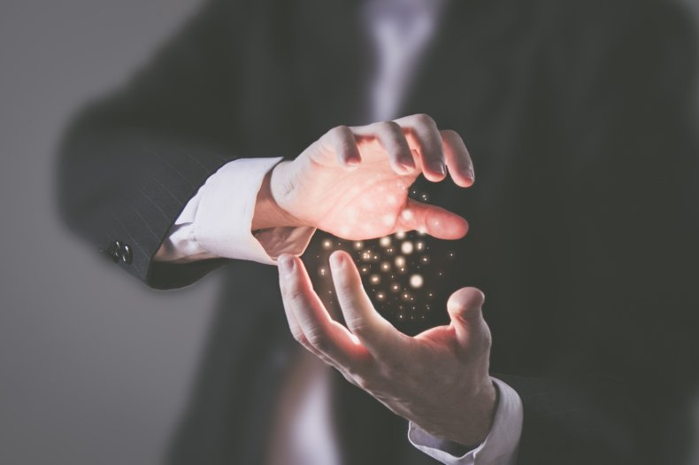 Man performing magic trick in hands.