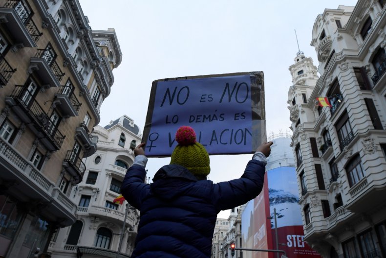 Woman in Spain holds rape placard