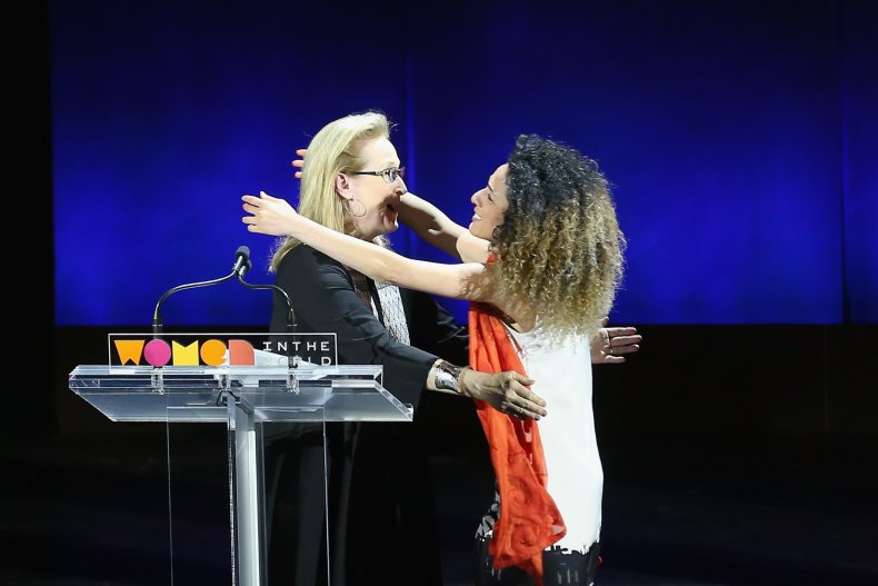 Masih Alinejad embracing Meryl Streep on stage.