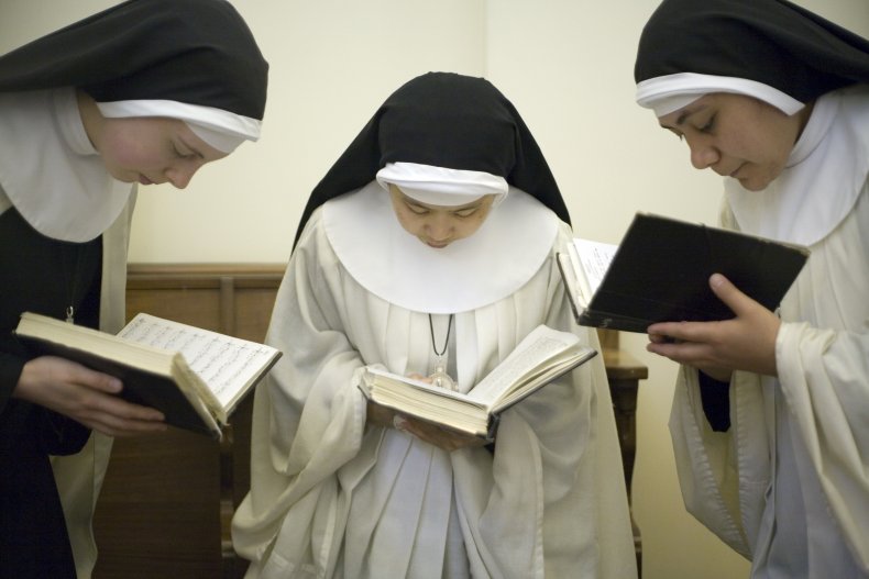 Three nuns praying with bibles