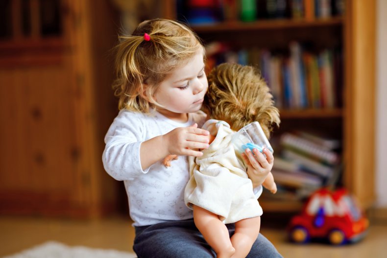 toddler playing with her doll