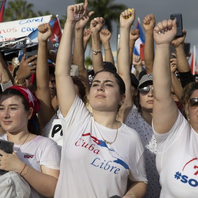 Protesters wearing Cuba Libre t-shirt raise fists