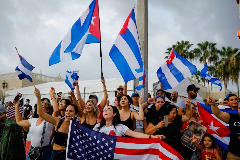 People demonstrate, some holding Cuban and US 