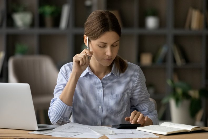 A woman concentrating while reviewing paperwork.