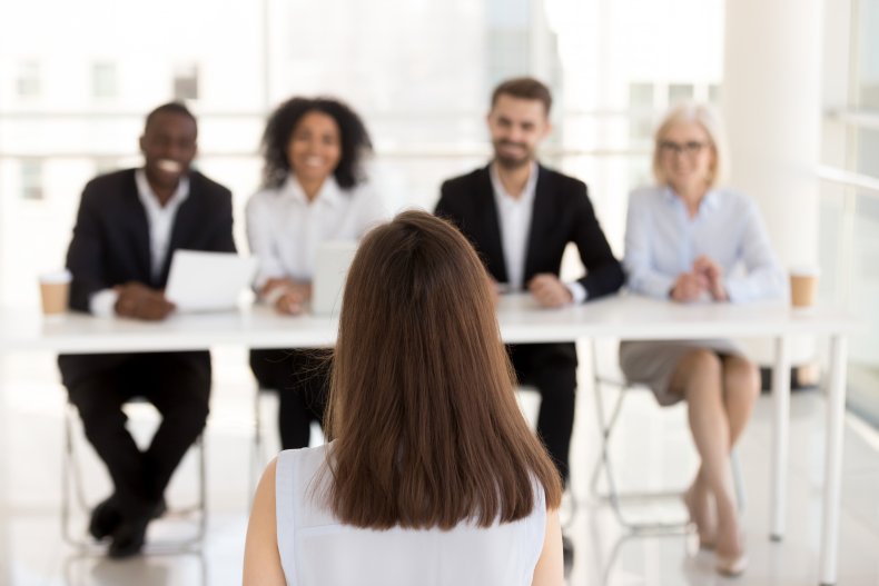 A woman being interviewed by a panel.