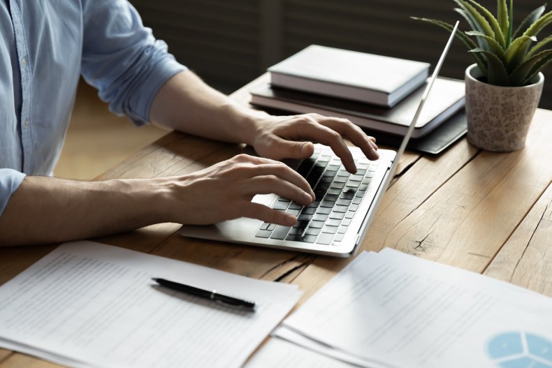 A person typing on a laptop.