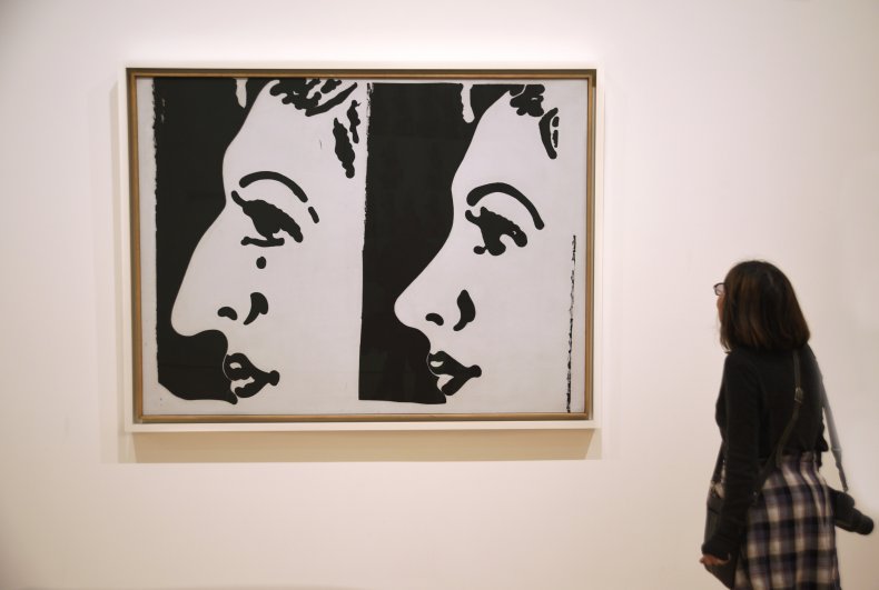 A museum visitor admires a 1961 painting