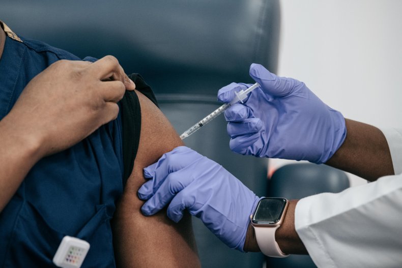 A COVID vaccine is administered