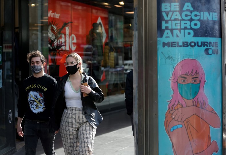 A couple walk past an advertisement