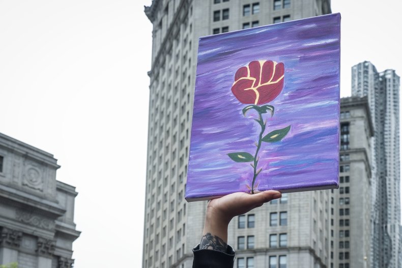 A protester carries a hand painted picture