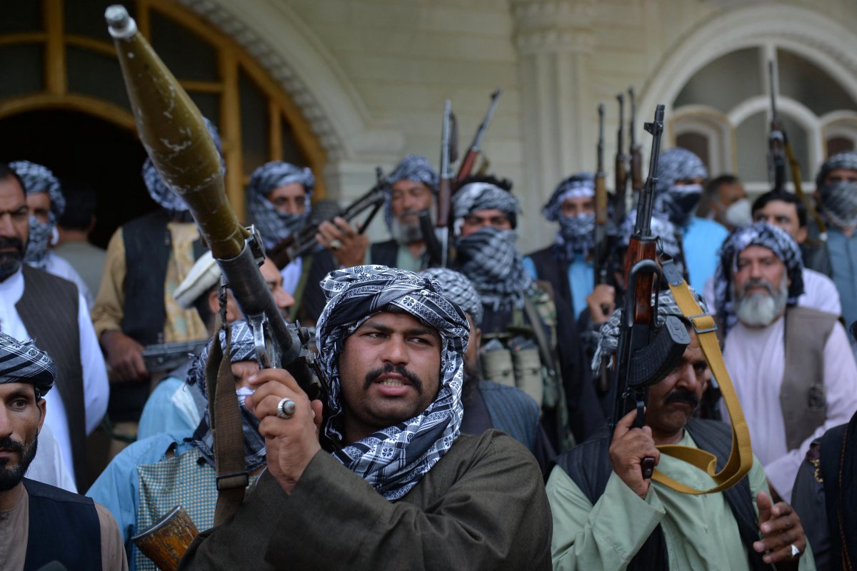 Afghan militia gather with their weapons