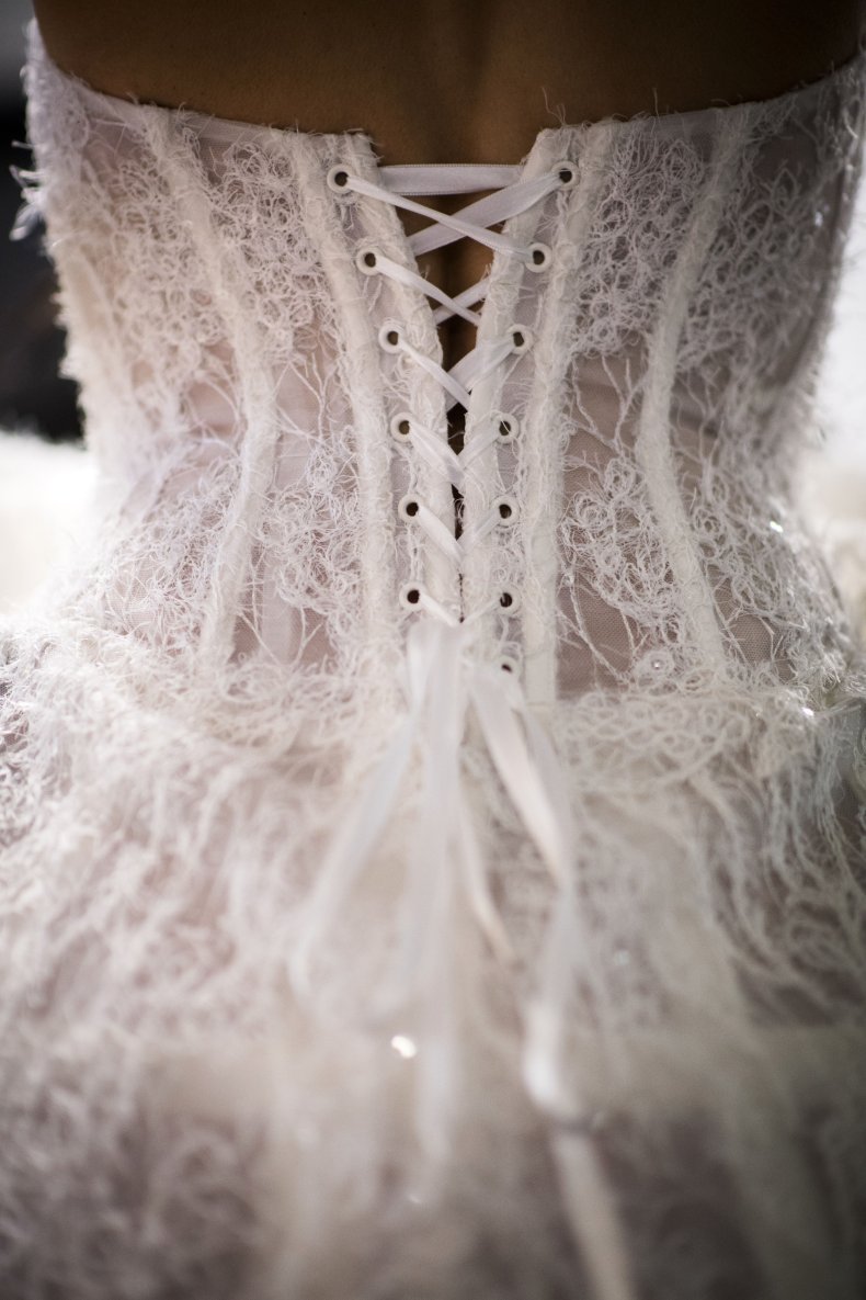 A bride wears a wedding dress.