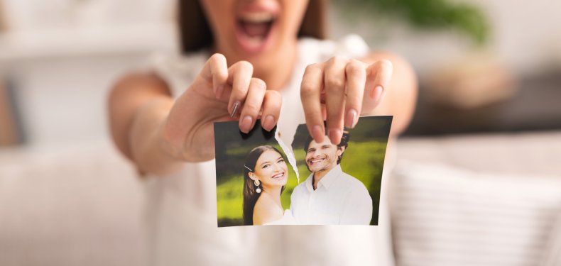 Woman tearing a photograph