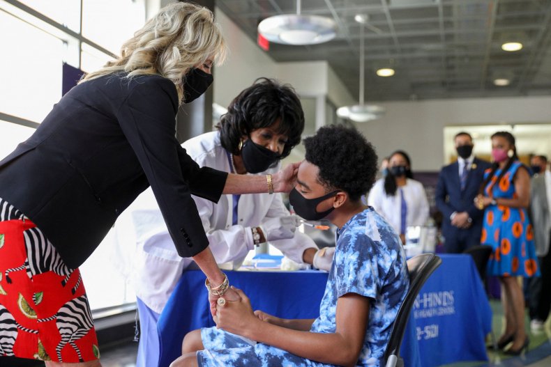 Jill Biden comforts a man being vaccinated.