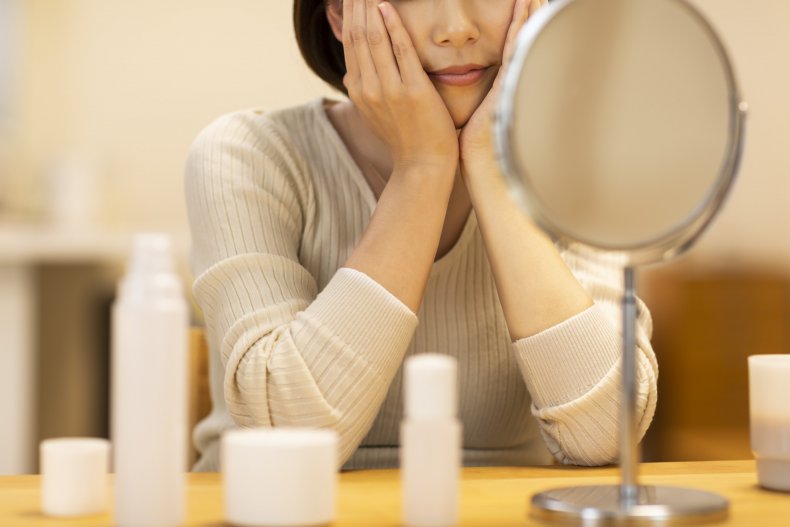 A woman looking in a mirror. 