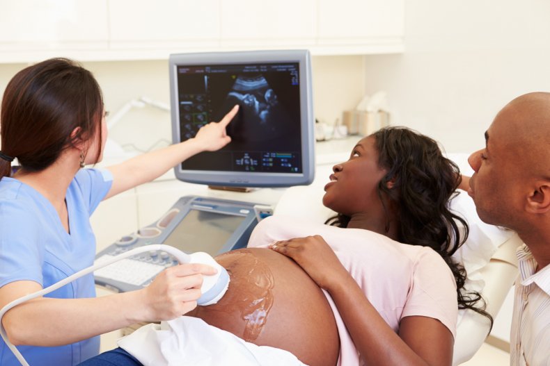 Pregnant woman having ultrasound scan