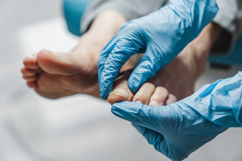 Podiatrist examining feet
