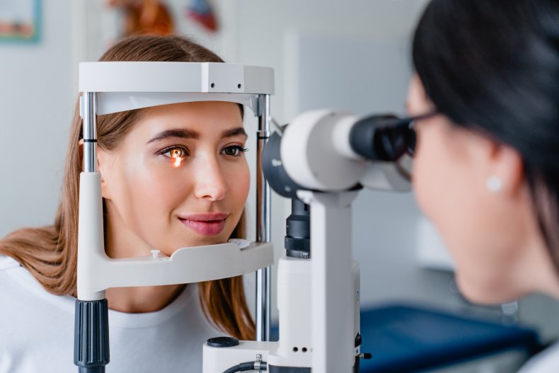 Optometrist examines patient's eye