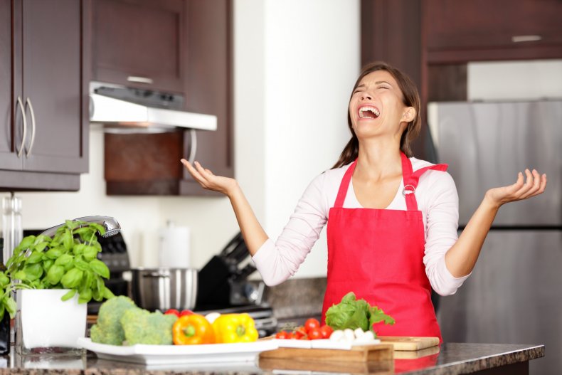 Woman looking stressed in a kitchen 