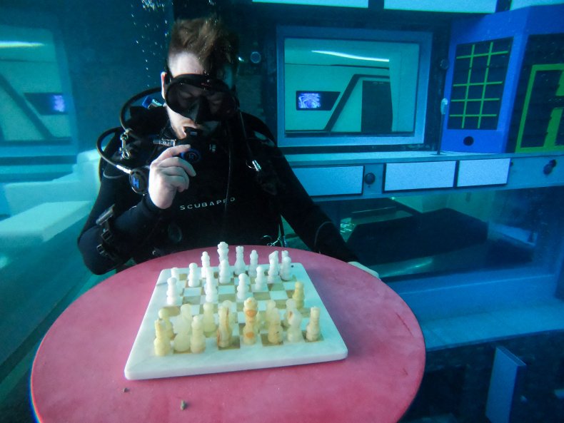 Diver playing chess in Deep Dive Dubai