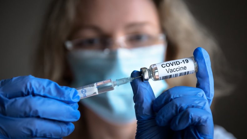 A COVID-19 vaccine and syringe.
