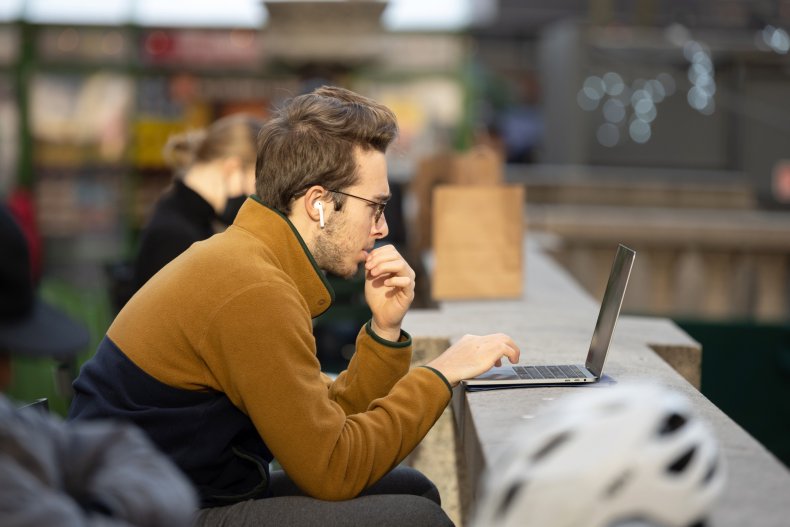 A man works on a laptop