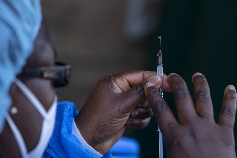 An army officer prepares to administer vaccine