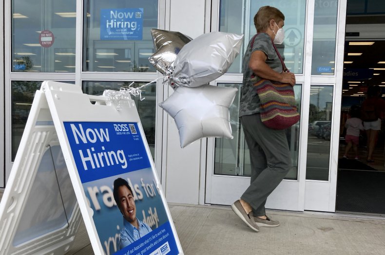 Woman Walks By Hiring Sign