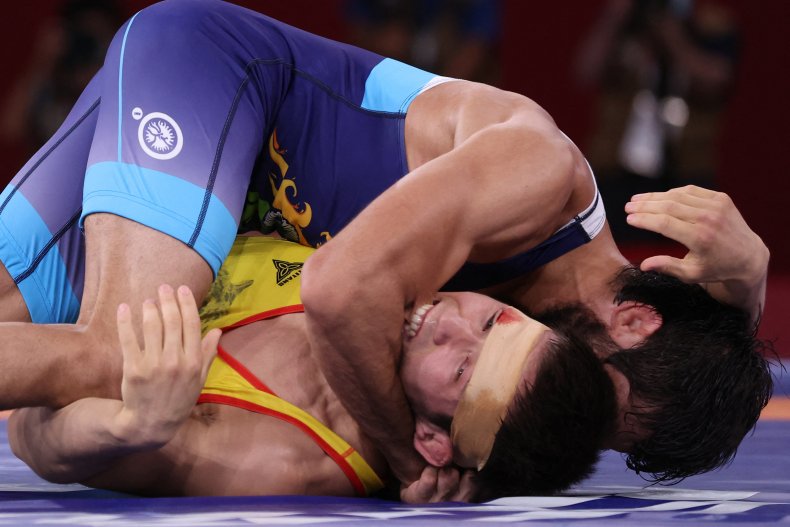 Nurislam Sanayev bites India's Kumar Ravi.