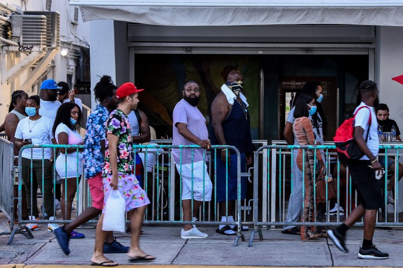 Customers queue outside bar in Miami