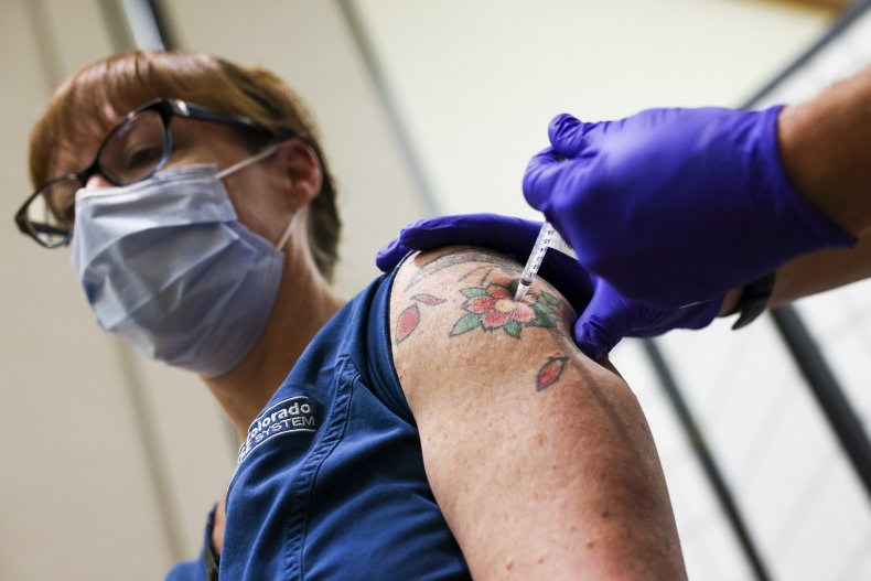 Nurse receives a COVID vaccine