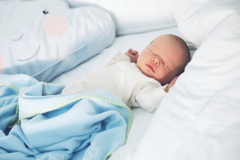 Newborn baby sleeps in crib