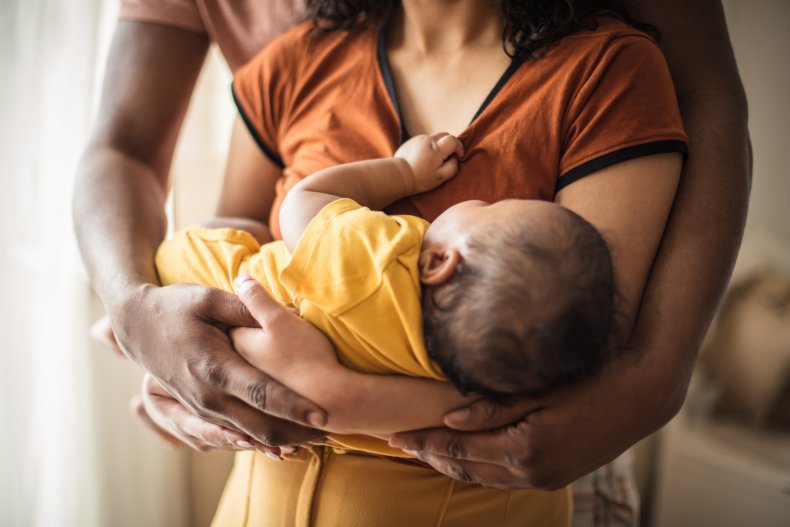 Couple hold sleeping baby
