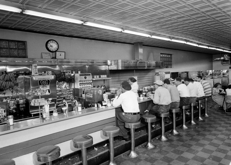 People eating in a 1950s diner