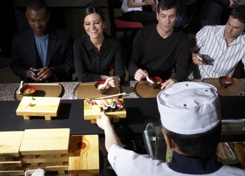 People in a sushi restaurant