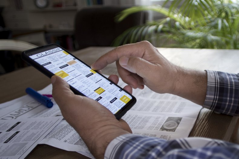 A man scrolling through classified adverts.