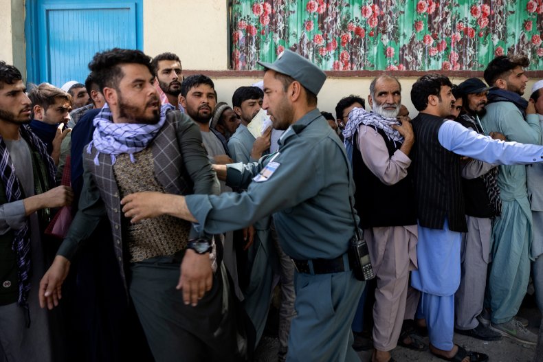 Afghans wait outside the passport office, Kabul.