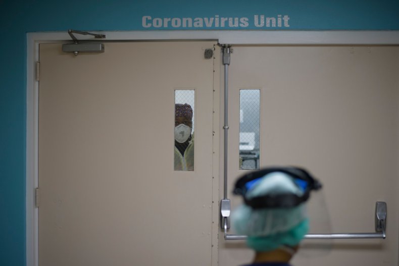 Healthcare workers looks out from COVID unit