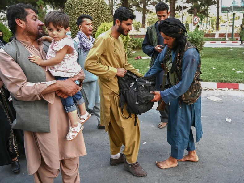 Taliban fighter searches bag