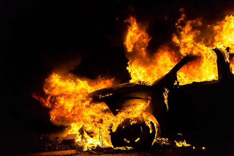 A picture of a burning SUV