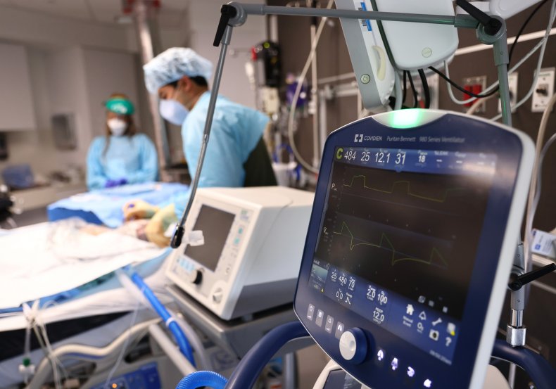 Clinicians care for a COVID-19 patient