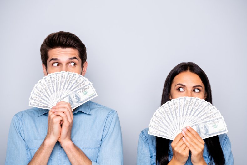 man and a woman holding cash