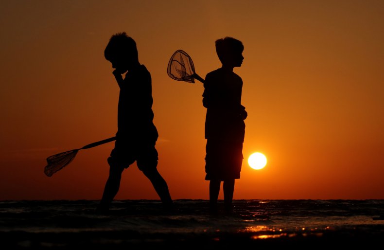 A silhouette of two children